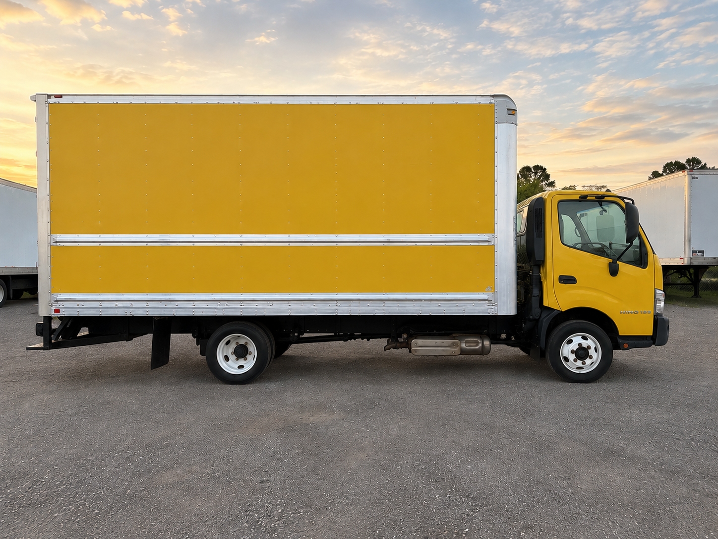 Side view of yellow box truck